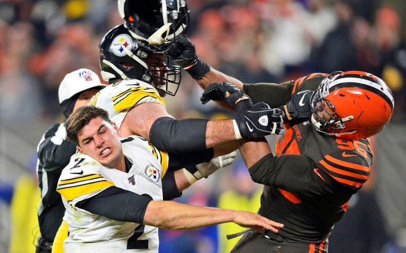 Cleveland Browns defensive end Myles Garrett hits Pittsburgh Steelers quarterback Mason Rudolph (2) with a helmet during the second half of an NFL football game, Nov. 14, 2019, in Cleveland.