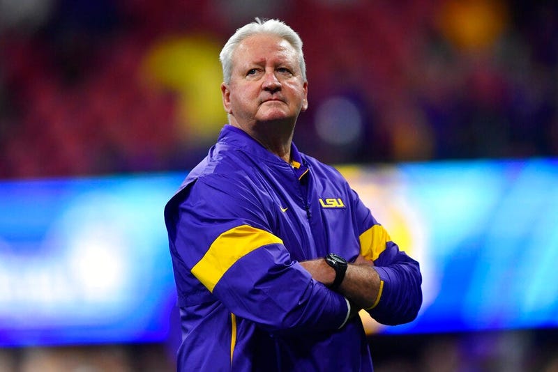LSU Offensive Coordinator Steve Ensminger watches teams warm up before the first half of the Peach Bowl NCAA semifinal college football playoff game between LSU and Oklahoma, Saturday, Dec. 28, 2019, in Atlanta. Ensminger's daughter-in-law, Carley McCord,