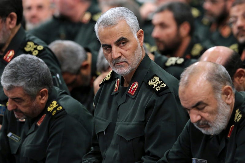 In this Sept. 18, 2016, file photo provided by an official website of the office of the Iranian supreme leader, Revolutionary Guard Gen. Qassem Soleimani, center, attends a meeting in Tehran, Iran.