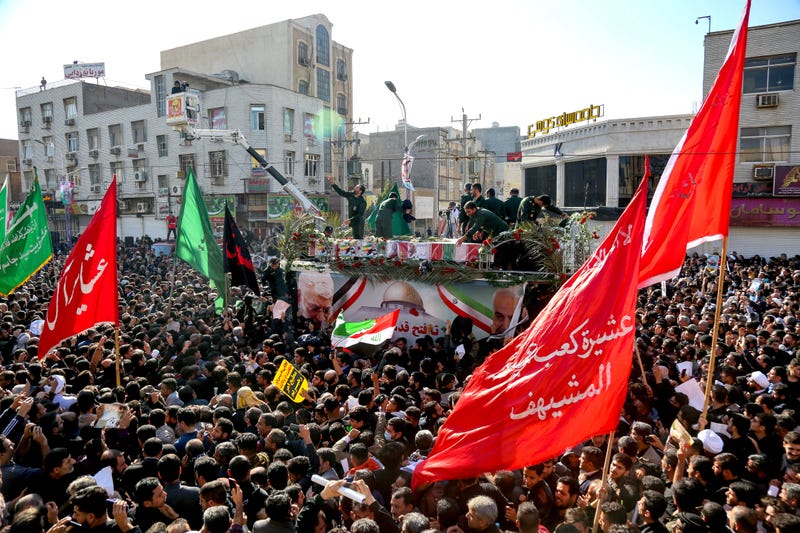 Flag draped coffins of Gen. Qassem Soleimani and his comrades who were killed in Iraq in a U.S. drone strike, carried on a truck surrounded by mourners during their funeral in southwestern city of Ahvaz, Iran, Sunday.