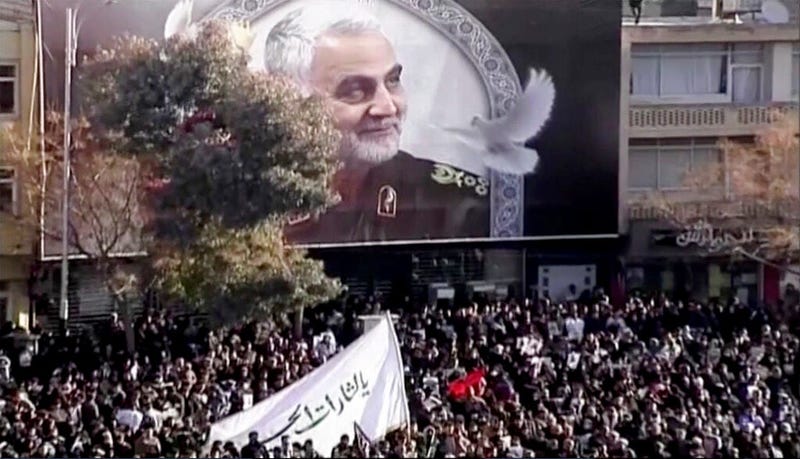 In this image made from a video, mourners gather to pay their respects to the slain Gen. Qassem Soleimani who was killed in a U.S. airstrike, in Kerman, Iran Tuesday, Jan. 7, 2020.