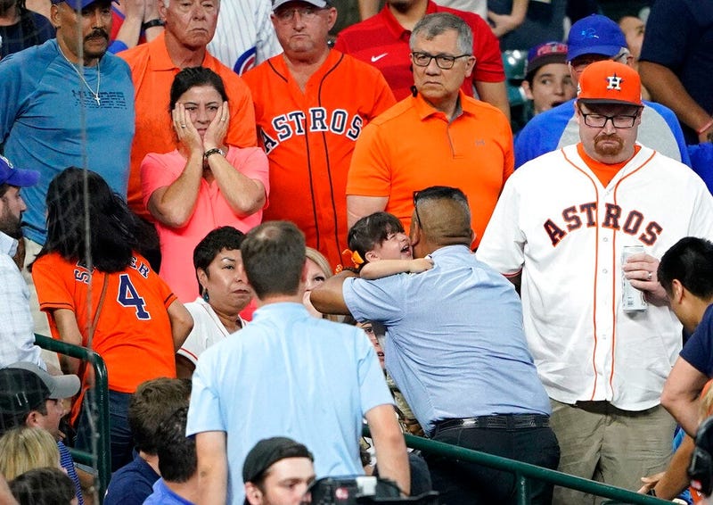 a young child is carried from the stands after being injured by a foul ball off the bat of Chicago Cubs' Albert Almora Jr.