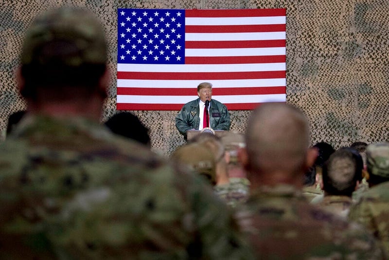 President Donald Trump speaks to members of the military at a hangar rally at Ain al-Asad air base, Iraq.
