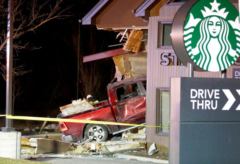 Personnel work at the scene in McHenry, Ill. where a vehicle drove into the Starbucks Thursday, Jan. 16, 2020.