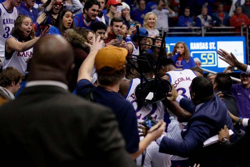 A fight between players spills into the crowd during the second half of an NCAA college basketball game between Kansas and Kansas State in Lawrence, Kan., 