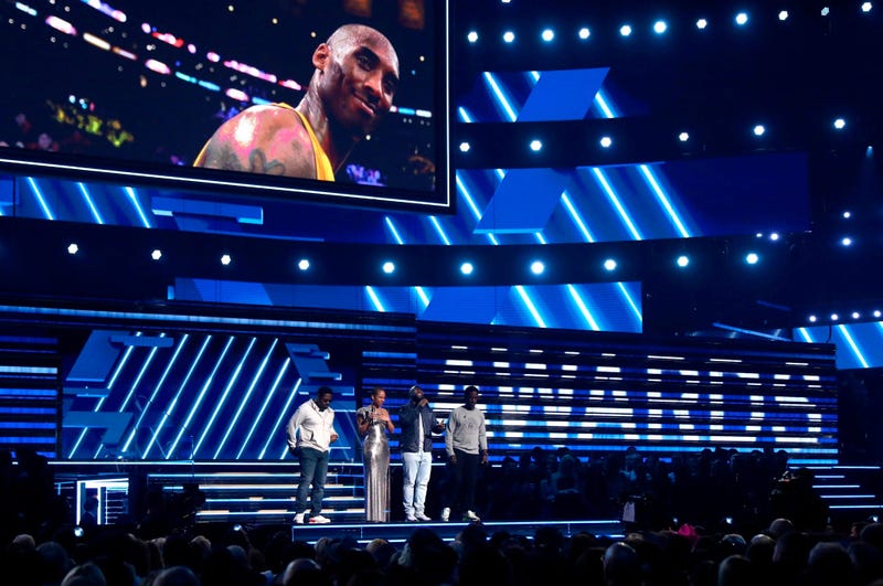 Alicia Keys, second left, and members of Boys II Men, from left, Nathan Morris, Wanya Morris and Shawn Stockman, sing "It's So Hard to Say Goodbye to Yesterday" during a tribute to the late Kobe Bryant, seen on screen, at the 62nd annual Grammy Awards.