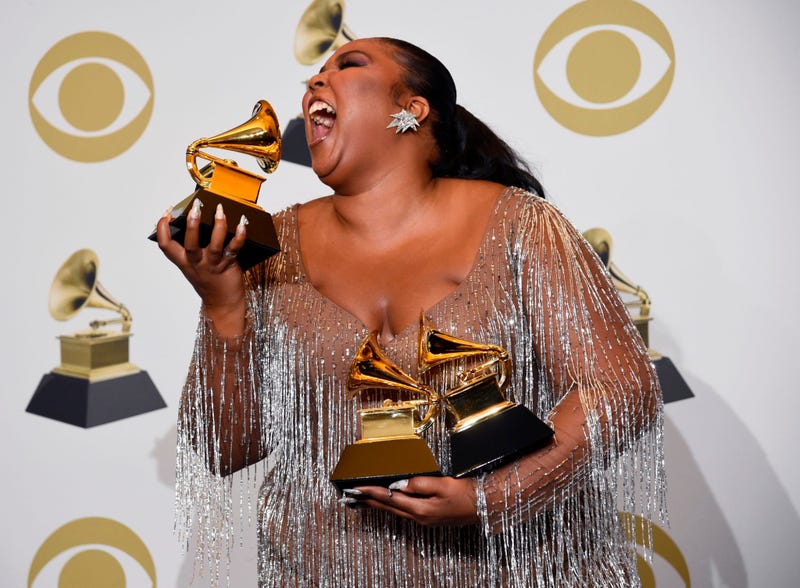 Lizzo poses in the press room with the awards for best pop solo performance, best urban contemporary album and best traditional R&B performance at the 62nd annual Grammy Awards at the Staples Center on Sunday, Jan. 26, 2020, in Los Angeles.