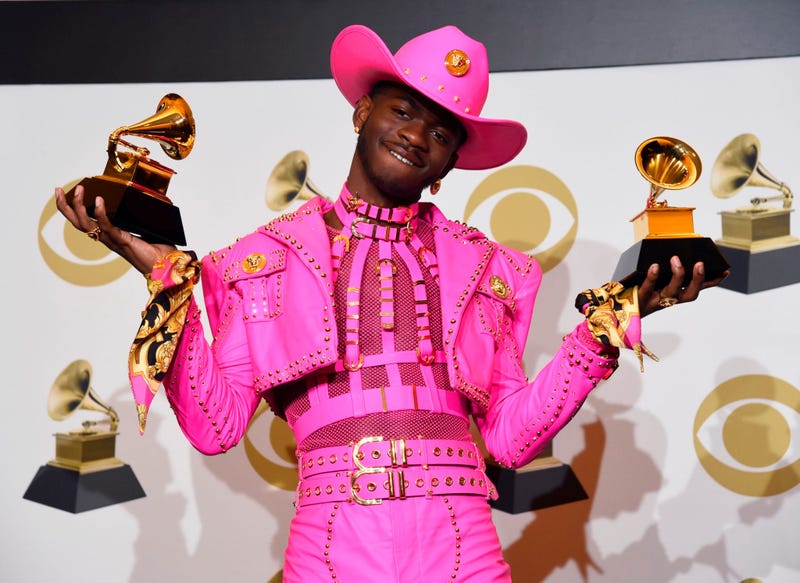 Lil Nas X poses in the press room with the awards for best music video and best pop duo/group performance at the 62nd annual Grammy Awards at the Staples Center on Sunday, Jan. 26, 2020, in Los Angeles.