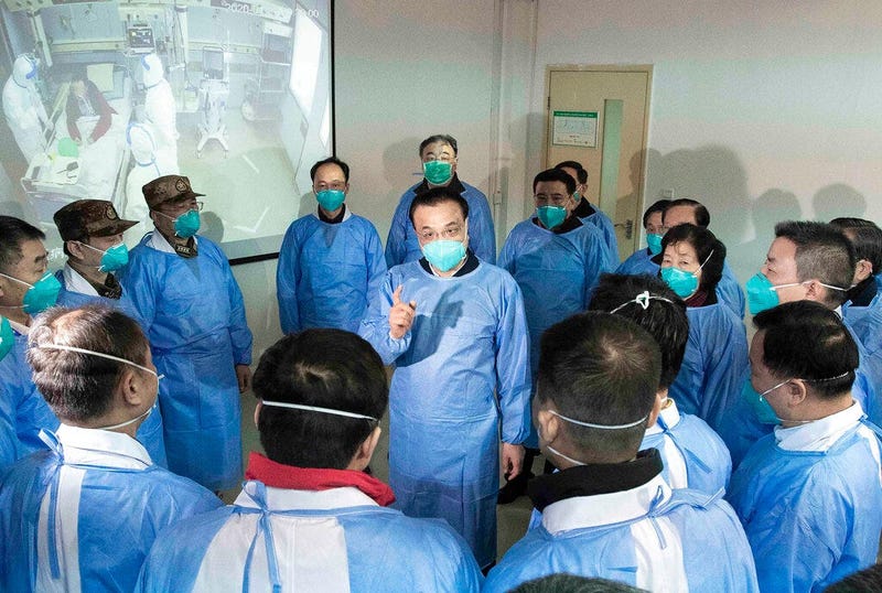 China's Xinhua News Agency, Chinese Premier Li Keqiang, center, speaks with medical workers at Wuhan Jinyintan Hospital in Wuhan in central China's Hubei province, Monday, Jan. 27, 2020.