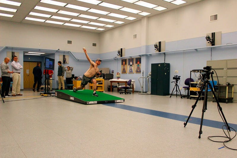 Central Connecticut pitcher Michael DeLease throws off a smart mound at the Center for Motion Analysis in Farmington, Conn. on Tuesday, Jan. 28, 2020. The new technology allows scientists to better study pitching mechanics to enhance efficiency and preven