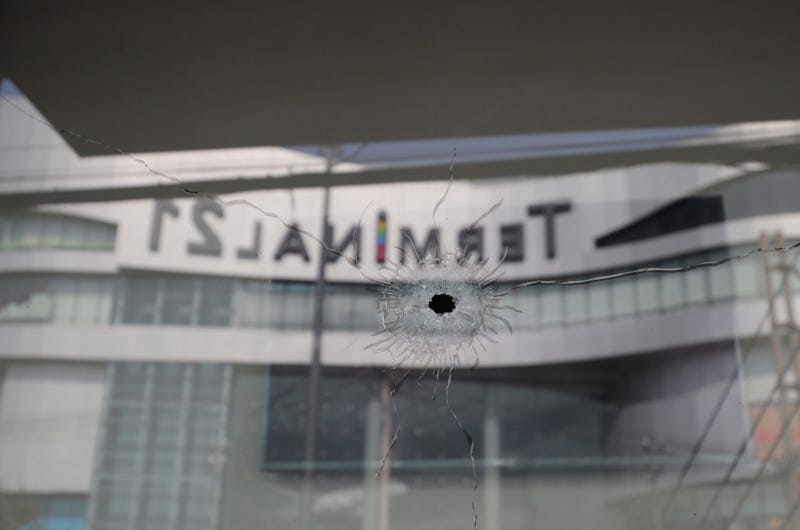 Bullet holes reflect the Terminal 21 Korat mall in Nakhon Ratchasima, Thailand, Sunday.