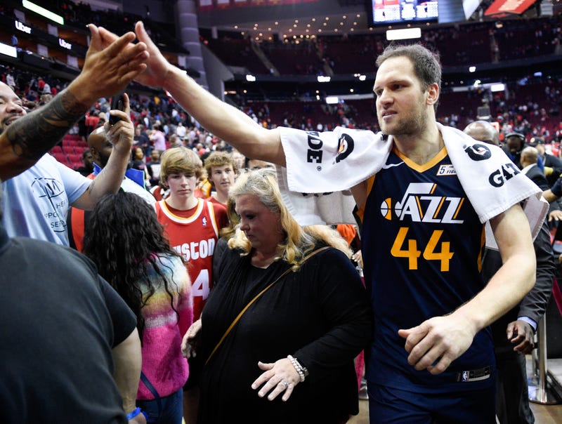 Utah Jazz forward Bojan Bogdanovic (44) high-fives a fan after shooting the game-winning three point basket during the second half of an NBA basketball game against the Houston Rockets, Sunday, Feb. 9, 2020, in Houston.