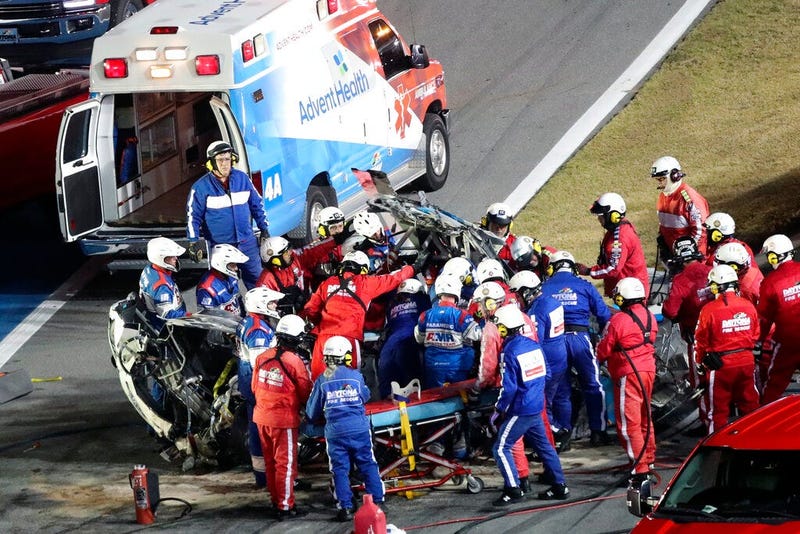 Rescue workers remove Ryan Newman from his car after he was involved in a wreck on the last lap of the NASCAR Daytona 500