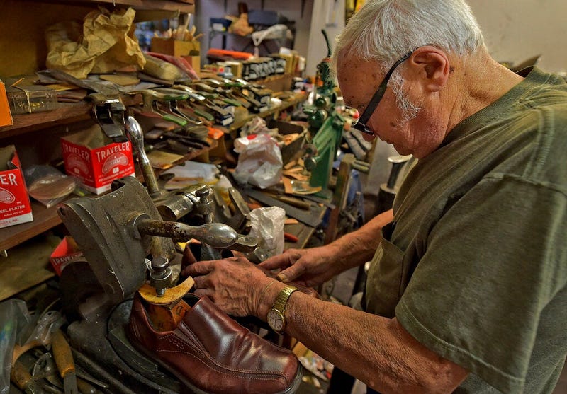 Tony Bonczewski repairs a heel on a customer's shoe at his cobbler shop in Wilkes-Barre, Pa.