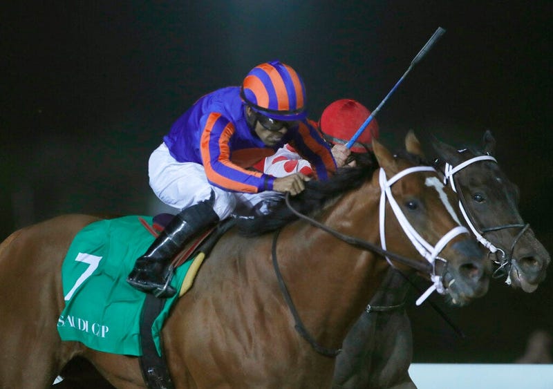 Jockey Luis Saez rides his horse, Maximum Security as he reaches the finish line of the $20 million, the Saudi Cup, at King Abdul Aziz race track in Riyadh, Saudi Arabia, Saturday, Feb. 29, 2020. The race is considered the world's richest horse race which