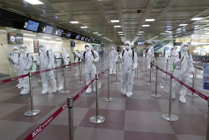 South Korean army soldiers wearing protective suits spray disinfectant to prevent the spread of the new coronavirus at Daegu International Airport in Daegu, South Korea, Friday, March 6, 2020.