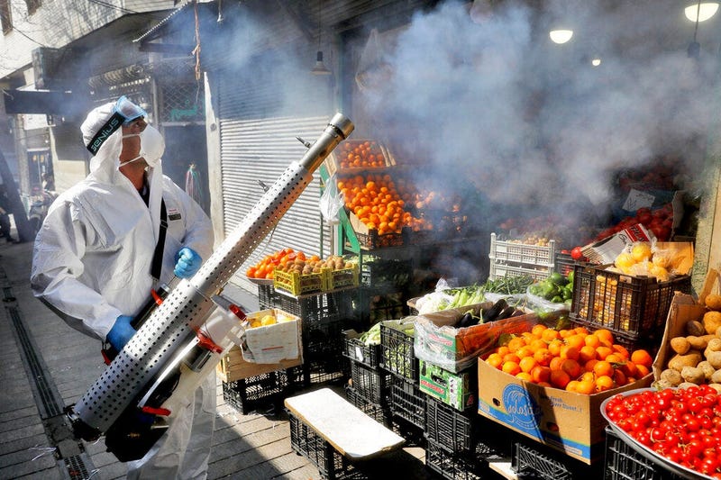 A firefighter disinfects a traditional shopping center to help prevent the spread of the new coronavirus in northern Tehran, Iran, Friday, March, 6, 2020. (AP Photo/Ebrahim Noroozi)