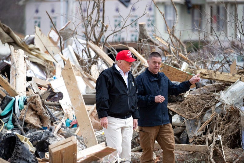 President Donald Trump speaks Mike Herrick, with Putnam County Rescue Squad, as he tours damage from a recent tornado, Friday, March 6, 2020, in Cookeville, Tenn. (AP Photo/Alex Brandon)