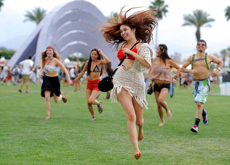  festivalgoers running toward the main stage at the 2012 Coachella Valley Music and Arts Festival in Indio, Calif. 
