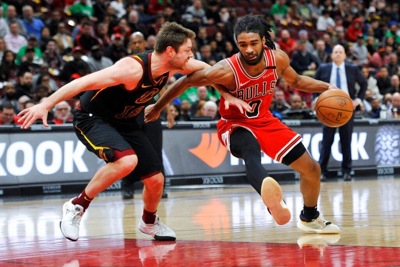 Chicago Bulls' Coby White (0) drives against Cleveland Cavaliers' Cedi Osman (16) during the second half of an NBA basketball game Tuesday, March 10, 2020, in Chicago. (AP Photo/Paul Beaty)