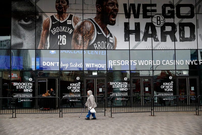 A pedestrian passes an entrance to the Barclays Center in the Brooklyn borough of New York on Thursday, March 12, 2020, after the NCAA's Atlantic 10 Conference Tournament was announced cancelled due to concerns over the COVID-19 coronavirus.