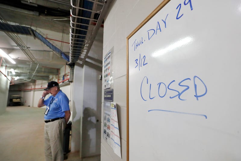 Hammond Stadium worker Paul Francis stands outside the Minnesota Twins' clubhouse after a game between the Twins and the Baltimore Orioles was canceled Thursday, March 12, 2020, in Fort Myers, Fla. Major League Baseball has suspended the rest of its sprin