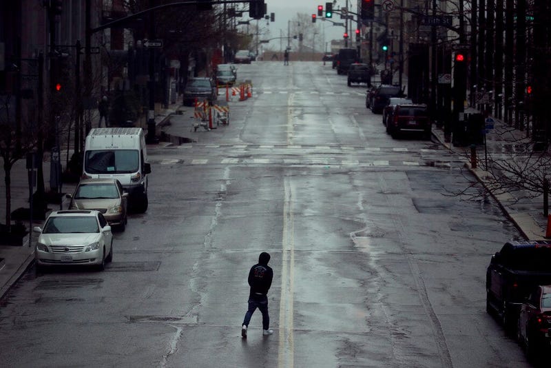  In this April 3, 2020, file photo a man crosses an empty street in downtown Kansas City, Mo. (AP Photo/Charlie Riedel, File)
