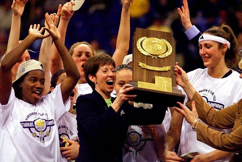  Notre Dame coach Muffet McGraw, center, holds up the National Championship trophy after Notre Dame 