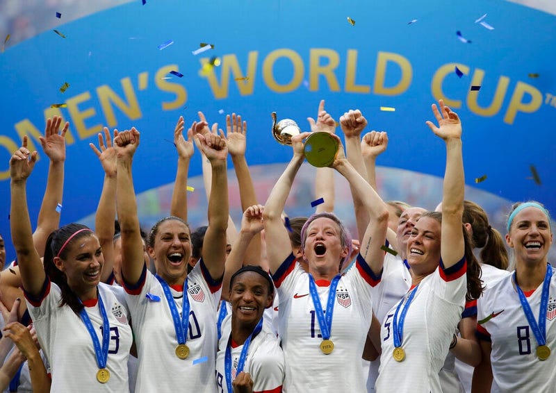 United States' Megan Rapinoe lifts up a trophy after winning the Women's World Cup final soccer match