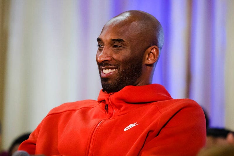 Former Los Angeles Lakers NBA basketball player Kobe Bryant listens to a question as he meets with students.