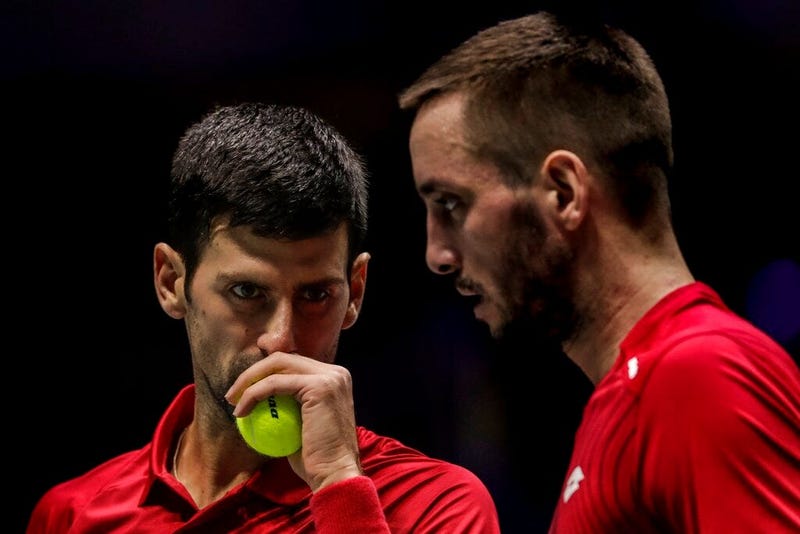 FILE - In this Nov. 22, 2019, file photo, Serbia's Novak Djokovic, left, and teammate Viktor Troicki play against Russia's Karen Khachanov and Andrey Rublev during the Davis Cup quarterfinal doubles match in Madrid, Spain. Another tennis player has tested