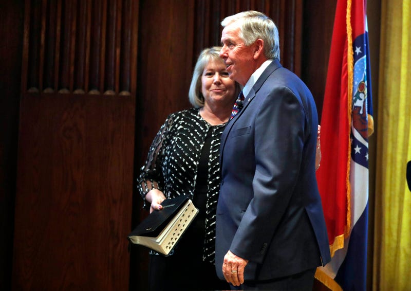 Gov. Mike Parson, right, smiles along side his wife, Teresa, after being sworn in as Missouri's 57th governor in Jefferson City, Mo.