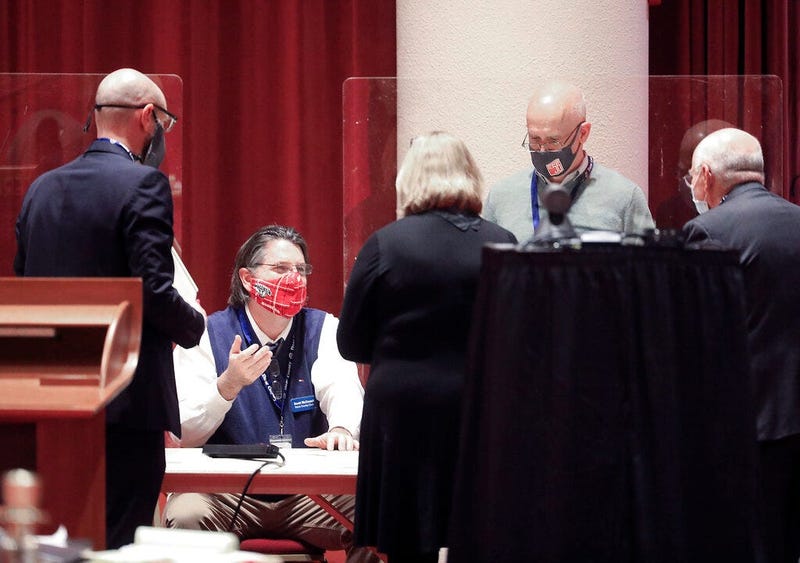 FILE - In this Nov. 20, 2020, file photo, Dane County Clerk Scott McDonell, seated, converses with election workers and legal representatives from the Joe Biden and Donald Trump presidential campaigns as a recount of the 2020 presidential election.