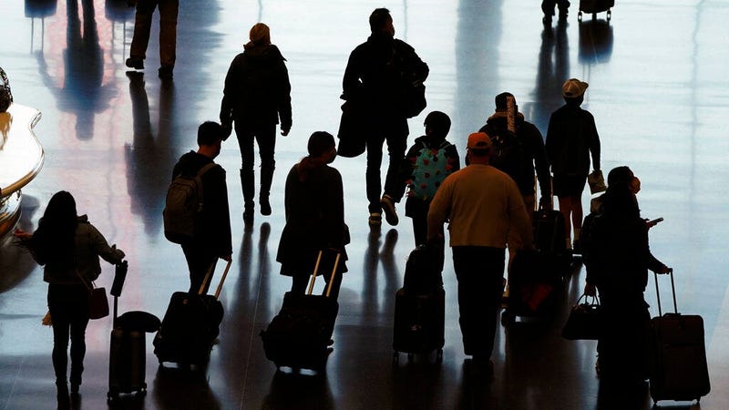 In this Wednesday, Nov. 25, 2020 file photo, travelers walk through the Salt Lake City International Airport in Salt Lake City, a day before Thanksgiving. (AP Photo/Rick Bowmer)