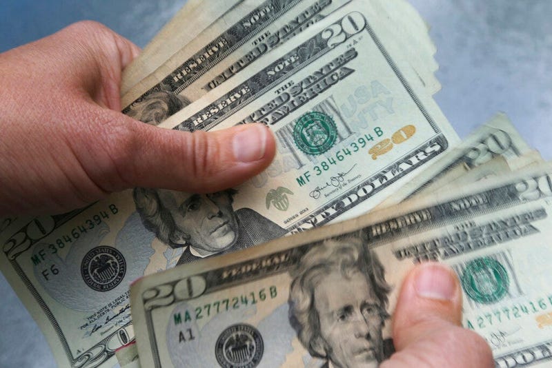 FILE - In this June 15, 2018, file photo, 20-dollar bills are counted in North Andover, Mass. 