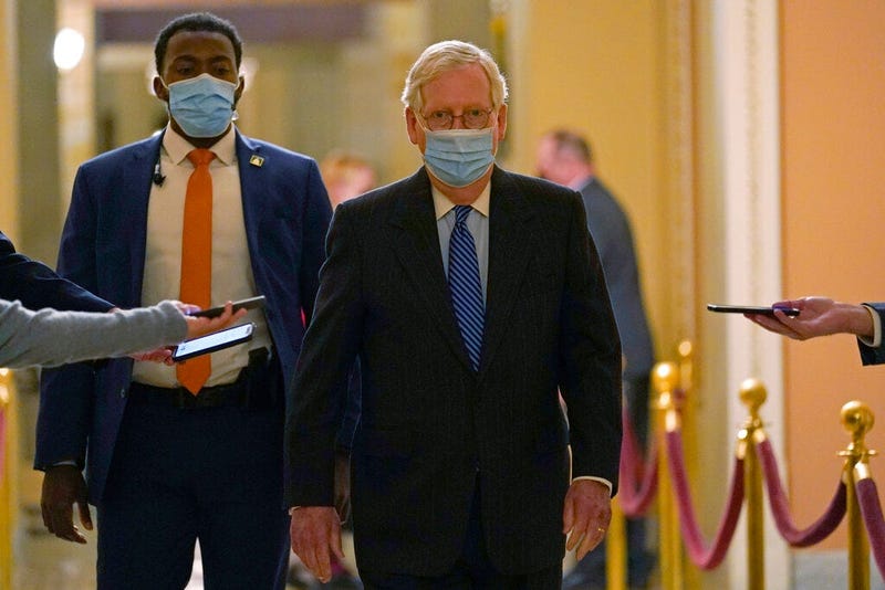 Senate Majority Leader Mitch McConnell of Ky., walks past reporters on Capitol Hill in Washington, Tuesday, Dec. 15, 2020.