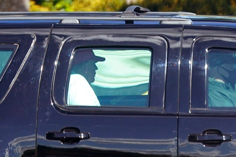 President Donald Trump rides in a motorcade vehicle as he departs Trump International Golf Club, Sunday, Dec. 27, 2020, in West Palm Beach, Fla. (AP Photo/Patrick Semansky)