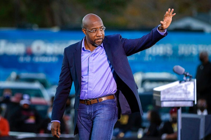 Democratic U.S. Senate candidate Rev. Raphael Warnock waves to supporters during a drive-in rally, Sunday, Jan. 3, 2021, in Savannah, Ga. (AP Photo/Stephen B. Morton)