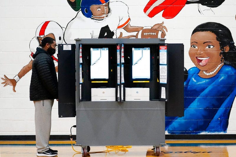 A person casts their vote during Georgia's Senate runoff elections on Tuesday, Jan. 5, 2021, in Atlanta. (AP Photo/Brynn Anderson)