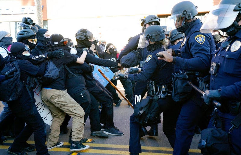 San Diego police clash with protesters after a gathering was declared an unlawful assembly, Saturday, Jan. 9, 2021, in San Diego.