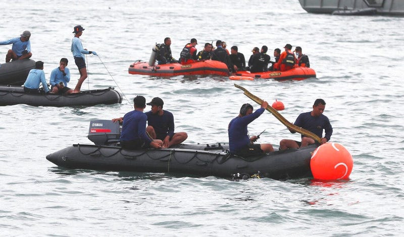 Rescuers carry debris found in the waters around the location where a Sriwijaya Air passenger jet has lost contact with air traffic controllers shortly after the takeoff, in Java Sea, near Jakarta, Indonesia,