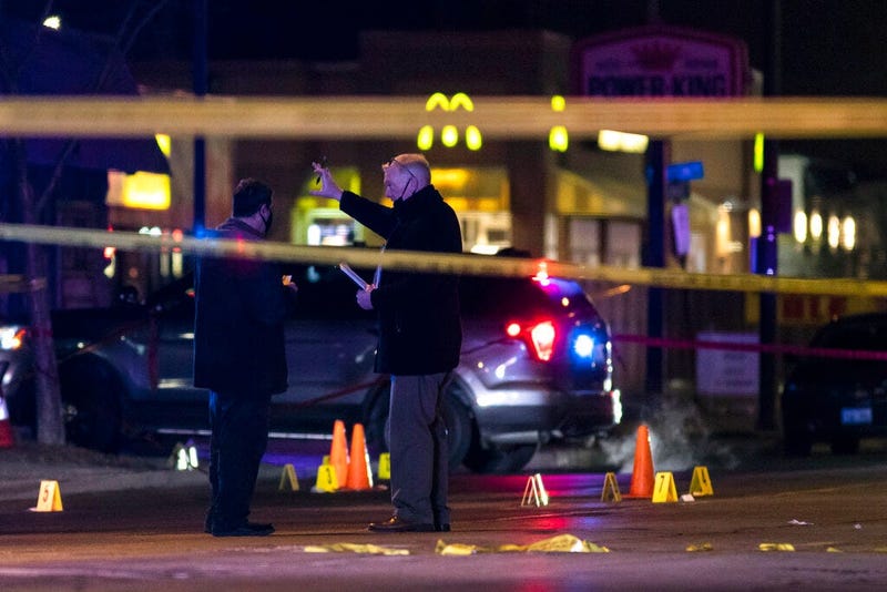 Chicago and Evanston police investigate a crime scene after a gunman went on a shooting spree before being killed by police during a shootout in Evanston, Ill., Saturday night, Jan. 9, 2021.