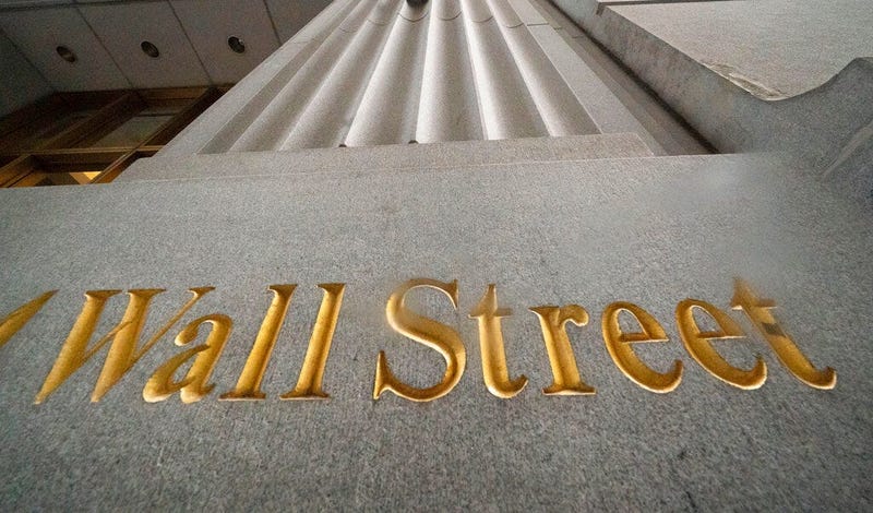 In this Nov. 5, 2020 file photo, a sign for Wall Street is carved in the side of a building. (AP Photo/Mark Lennihan, File)