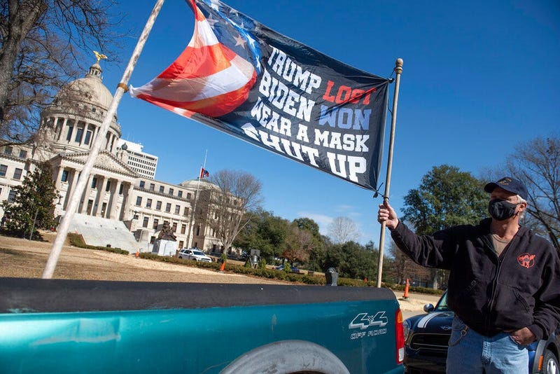 Dale Gibson, of Jackson, Miss., shows off the banner he planned to hold as a counter-protester if a pro-Trump rally materialized Sunday, Jan. 17, 2021.