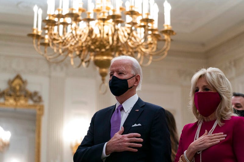 President Joe Biden, accompanied by first lady Jill Biden, places his hand over his heart during a performance of the national anthem, during a virtual Presidential Inaugural Prayer Service.  (AP Photo/Alex Brandon)