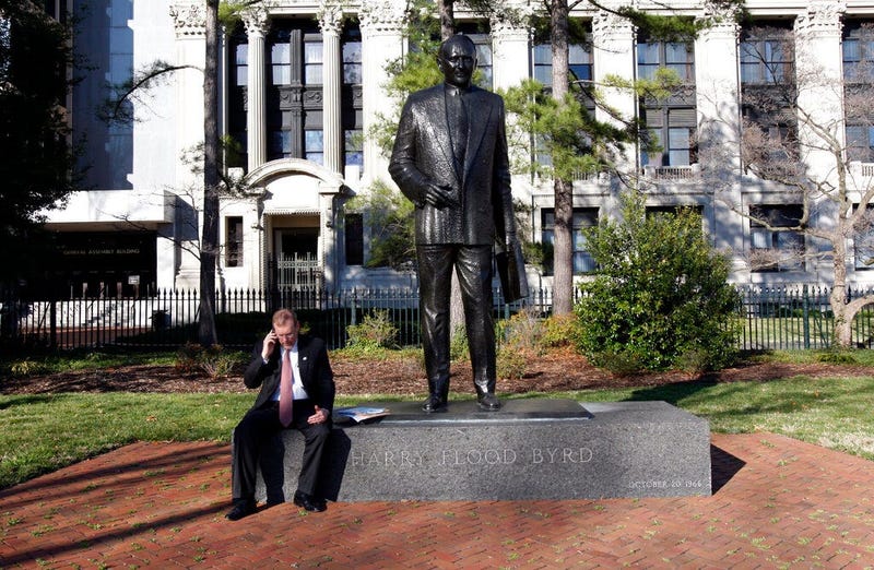 FILE - House Majority Leader H. Morgan Griffith, R-Salem, talks on a phone as he sits at the feet of the statue of former Gov. and U.S.