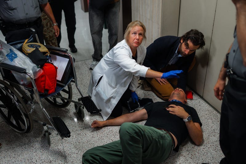 Journalist L. Vural Elibol receives medical assistance after being shoved by federal agents in immigration court on Tuesday, Sept. 30, 2025, in New York