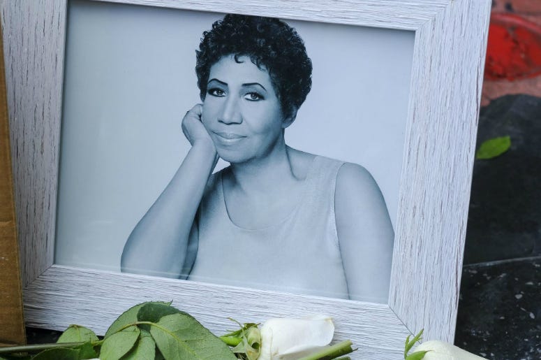 People pay their respects with flowers and pictures on Aretha Franklin's star at the Hollywood Walk of Fame in Los Angeles. Aretha Franklin, the "Queen of Soul," died Thursday in her home city of Detroit after battling pancreatic cancer.