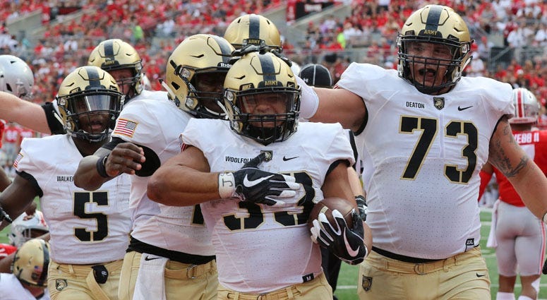 Army running back Darnell Woolfolk (33) celebrates a touchdown with teammates against Ohio State on Sept. 16, 2018, in Columbus, Ohio.