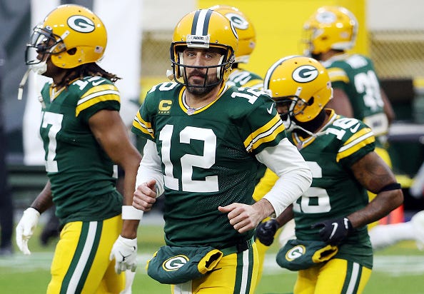 Aaron Rodgers rushes to the huddle with the Packers